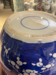 A pair of large Chinese blue and white 'prunus' jars and covers, 19th C.
